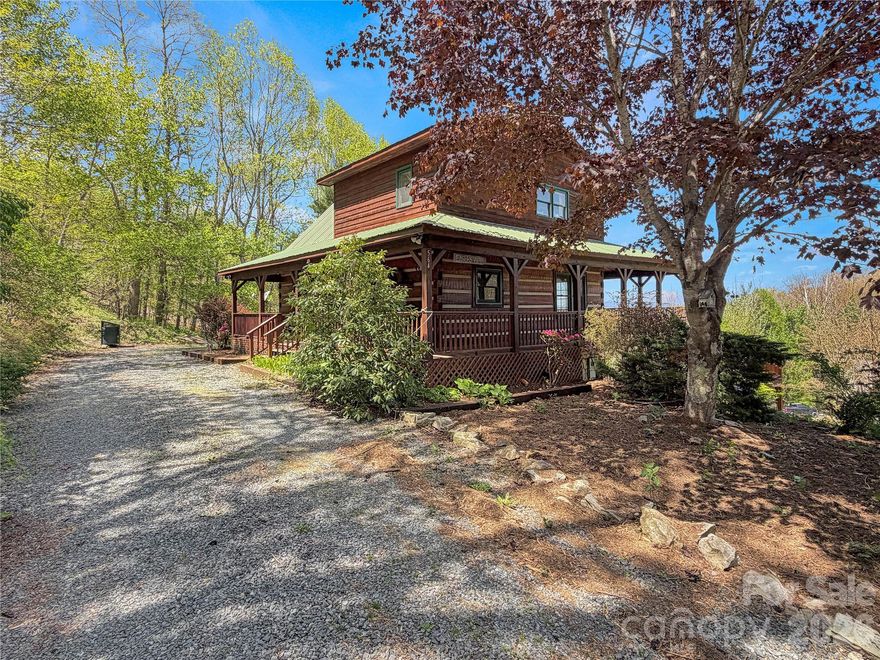 Welcome to Eagles View Cabin, a classic log cabin retreat tucked just outside Foscoe and Valle Crucis in the heart of the High Country. Set off the beaten path yet still convenient to everything, this mountain home is a 20~ minute drive to Boone and Banner Elk, and only about 10 minutes to historic Valle Crucis, Mast General Store, and Valle Crucis Community Park. Situated at approximately 3,600 feet in elevation, the cabin offers long-range mountain views and a rare 1.57-acre double lot with a flat, open yard—an uncommon find in the mountains. The expansive green space is ideal for dogs, gardening, outdoor games, frisbee golf, gathering around the firepit, or possibly adding an additional structure. The main level showcases true log cabin character with real log construction, tongue-and-groove ceilings throughout, a generous kitchen and dining area with abundant built-in storage, and a warm living room with soaring vaulted ceilings, a wood-burning fireplace, and access to the covered back porch. The wraparound covered porch extends the living space outdoors, offering a wonderful place to take in the mountain views and fresh High Country air. Upstairs, the spacious primary loft suite features vaulted ceilings, a closet, ensuite bath, large windows, natural light, and mountain views. The loft could also be converted into an enclosed bedroom if desired. The lower level includes two oversized secondary bedrooms with access to the lower covered deck and yard, along with a full bath, laundry room, storage room, and additional closet space. Being sold furnished, Eagles View Cabin is well suited as a full-time residence, seasonal mountain getaway, or short-term rental. The home also offers ample parking and easy access to the main level. Located in the desirable Valle Crucis school district, and within Hunters Ridge—an established cabin community in the center of the High Country—this property combines many features that are hard to find together: a large usable yard, long-range views, central location, mountain character, and flexible use potential. From quiet mornings on the wraparound porch to evenings around the firepit, Eagles View Cabin invites you to embrace the mountain lifestyle.  Sold fully furnished.
