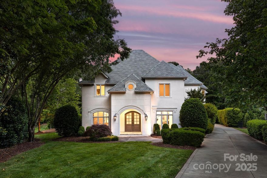Located in the highly desirable Ballantyne Country Club, this 5BR/4.5BA home blends modern luxury and timeless design. With 4,500+ sqft, it features a sleek updated kitchen with Thermador 6-burner cooktop, wet bar, and views to the resort-style pool. The 2-story great room boasts soaring 20-ft ceilings and abundant natural light. Main level includes bedroom suite, ideal for guests or office space. Upstairs offers a spacious primary suite with dual walk-in closets, 3 more bedrooms, 2 full baths, and a large bonus room. Upgrades include refinished concrete on main, hardwoods, custom lighting, and designer drapery. Outside, turf and pavers lead to a private retreat—lush hedges, putting green, fenced yard, and resort-style pool. Sellers had a pool house professionally designed to enhance privacy, guest space, and reduce road noise—ASK AGENT FOR PLANS. Enjoy green space, 3-car garage, and access to walking trails, dog park, playground, and basketball court.