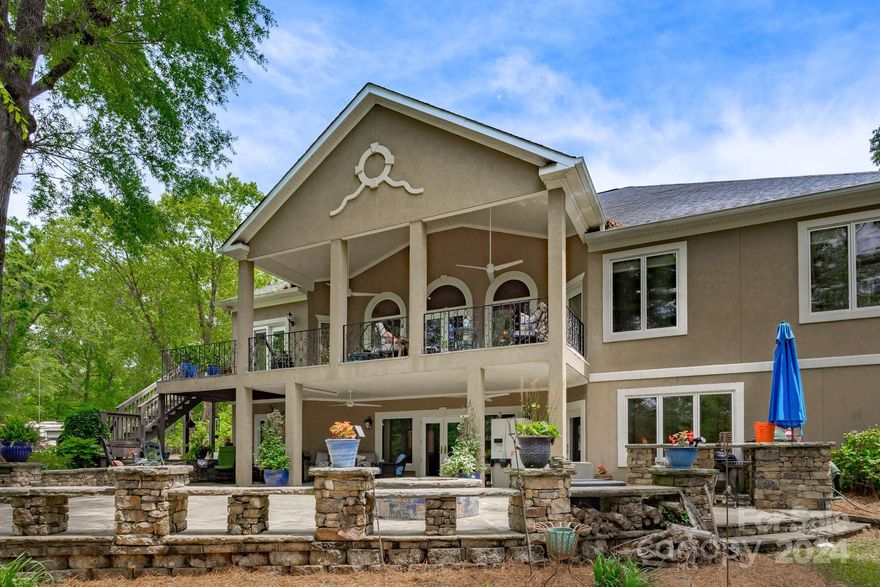 Stunning custom home located on the northern end of the lake makes the commute to Rock Hill/Charlotte area a breeze.Once you pull in the paved drive, the extensive landscaping and stonework will tell you this is no ordinary lake house.Built in 2000, the kitchen and master bath recently updated by House of Drennan stytlists looks sharp with two tone granite, beautiful cabinetry, hardware and new KitchenAid appliances. The expansive master suite is appointed with large closets, automatic lighting, and updated spa shower.The master and guest suite on the main floor boast cherry wood floors along with a laundry room, breakfast area, formal dining and large open family room with built ins, fireplace and entry to the gorgeous covered balcony.On the lower level, there's entertainment space with a bar, a walk in vault and 2 large bedrooms that lead to the stone patio with outdoor bar/grill area, fire pit and gorgeous landscaping.The 2 acre parcel across the street includes a 2700 sq ft garage.