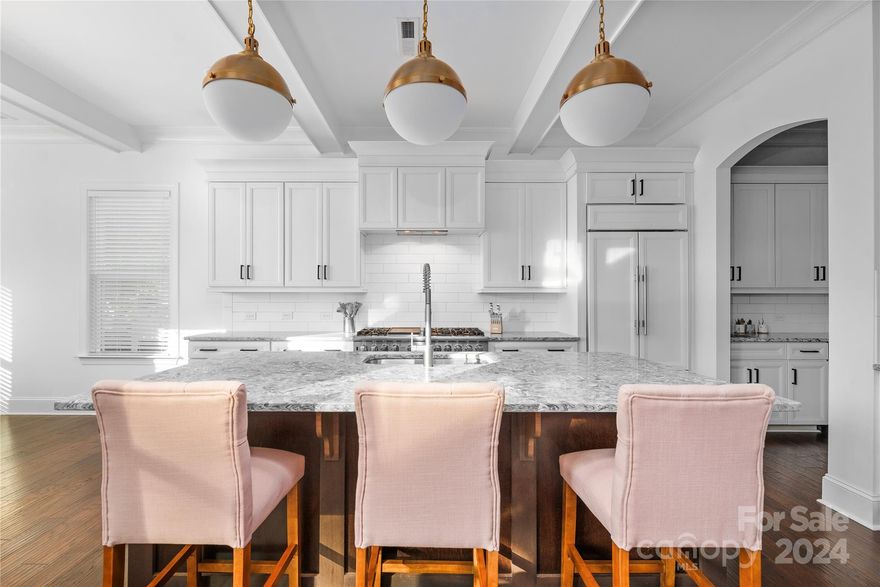 Situated in the desirable Cotswold neighborhood, this property boasts a fenced yard, a 3-car garage, and circular driveway. The kitchen is a chef’s dream with quartz countertops, high-end appliances (custom Subzero paneled fridge, 60 in' Viking range w/ double oven and griddle cooktop, Bosch dishwasher, & more), a grand island, and a butler’s pantry with wet bar. The main floor features a luxurious Owner's Suite with double custom closets, a spa-like bath, a spacious 6-foot tub, and dual shower heads. An additional bedroom, full bathroom, 10ft coffered ceilings, and a dedicated home office complete the downstairs. Upstairs, you'll find 3 large bedrooms, multiple bathrooms, an oversized game room, and ample storage. The kitchen and patio are pre-wired for speakers, perfect for entertaining. Located less than 5 miles from Uptown, SouthPark Mall, and minutes from top private and public schools.