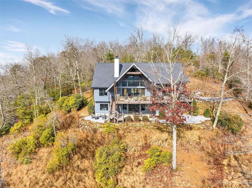 Exceptional, like-new, move in ready 3BR/3.5BA custom home situated on 3.6+/- acres with sweeping mountain views at The Homestead at Mills River.  This light filled home features an open plan, two story Great Room with beautiful fireplace, gourmet chef's kitchen with stainless appliances, spacious master suite with luxurious bathroom and large closet, and main level covered porch with fireplace and panoramic mountain views.  The lower level features polished concrete floors, two bedroom suites, kitchenette, office, exercise room, and walk out covered patio and firepit.  A two car garage, level parking area, and gentle site, all just minutes from South Asheville and the Asheville airport make this home a MUST SEE.