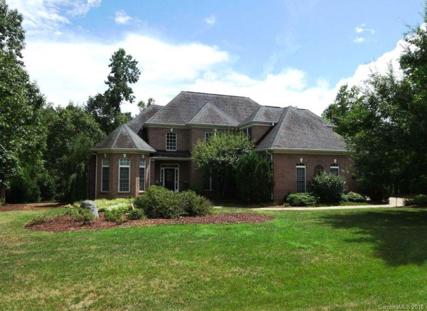 Picture perfect setting! Custom FULL BRICK home situated on a private, 1.8 acre lot w/fabulous screened porch that has wood burning FP. Professionally landscaped, irrigation, 3 car garage, storage shed. Beautiful HWS thru main living areas. Extensive moldings/trim. Soaring 2 story foyer & GR w/gas FP. Chef's Kitchen offers granite, tile backsplash, SS appl, 5 burner gas cooktop, HUGE center island. Formal DR. Main level Master Suite + Guest Suite. 2 BRs + Bonus/5th BR up. Tankless water heater.