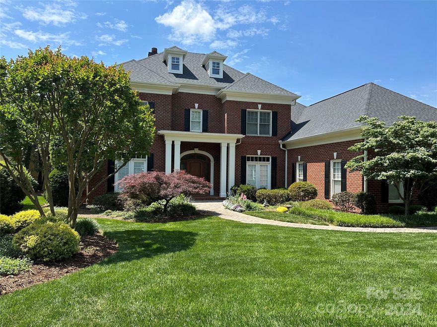 Classic brick home In Ballantyne Country Club.  Home was built and renovated by Arcadia Homes.  Fabulous open basement with bar and second laundry and pool bathroom.  Outside enjoy a gorgeous pool with in floor cleaning, hot tub, travertine and gas fireplace.  Also upstairs outside is a 390 sq ft screened porch with tv and 277 ft covered porch with built in gas grill and beautiful view of the leisure trail.  Inside there are dual staircases to second floor, walk up attic, dishwasher drawer and warming drawer in kitchen.  Guest bedroom on first floor and bonus room upstairs.  Huge second floor laundry with laundry sink.  Primary bathroom has two closets with builtin shelving and drawers, dual vanities, large shower with three shower heads, separate jacuzzi tub and heated flooring.  Three car garage with two keypad controlled doors and built in cabinets. Meticulously maintained throughout the years.  Professionally landscaped and maintained yard that looks beautiful the entire year.