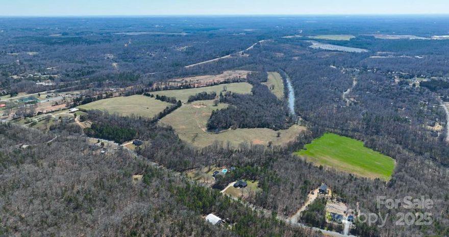 Discover a rare opportunity to shape a premier residential community in one of Concord’s most sought-after and fast-growing areas. This expansive ±138 acre property offers the perfect balance of seclusion, natural beauty, and accessibility. Tucked away in a peaceful, wooded setting, the land features miles of scenic frontage along the Rocky River, providing a serene and picturesque backdrop, ideal for a thoughtfully planned neighborhood. Despite its quiet atmosphere, the property offers easy access to Highway 601, placing future residents just minutes from schools, shopping, dining, and major commuter routes. With gently rolling terrain, mature trees and riverfront vistas, the possibilities are endless. Whether you're envisioning a luxury gated enclave, estate-style homes, or a master-planned community that embraces and enhances the natural landscape, this is a blank canvas for your vision. Additional parcels available for a total of ±278 acres. Access is only available via a scheduled and approved showing.