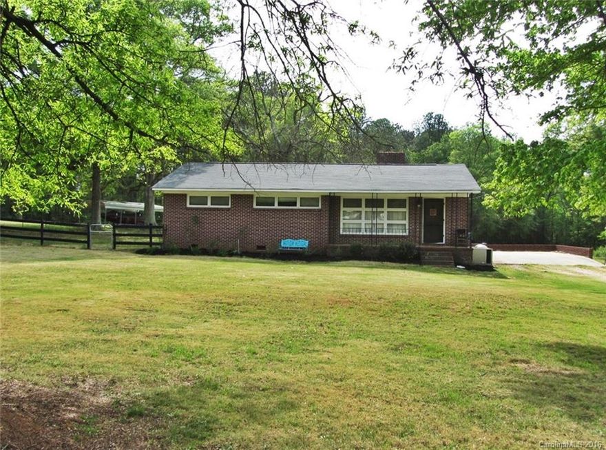 Make this house your home.  All brick 3 bedroom home on 7.04 acres of land!  Interior features include an updated kitchen, wood stove in den and large master bedroom. Sunroom and large laundry room add an additional unheated 244 sq ft to the home.  Storage building to keep all your outdoor equipment.  Minutes to I-77!