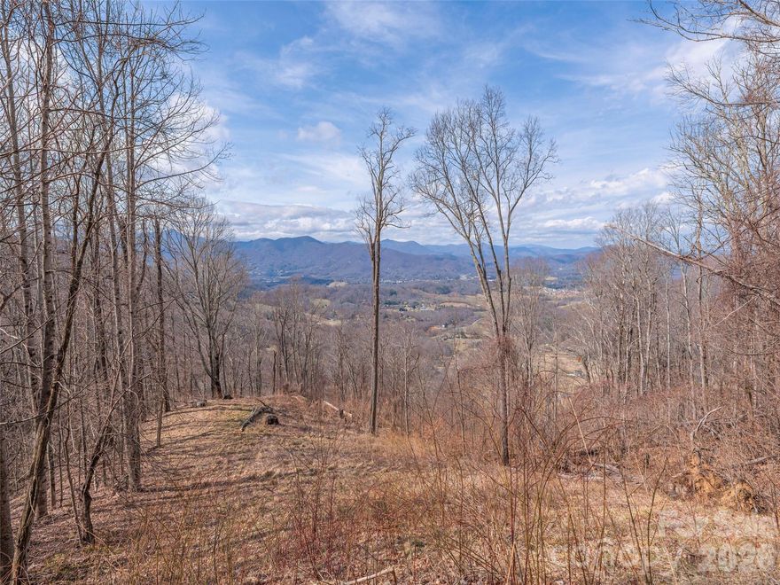 Discover the perfect blend of privacy, natural beauty, and convenience with this exceptional 10-acre parcel just minutes from downtown Waynesville. Tucked away in a serene setting that offers a remarkable sense of solitude, the property is only a five-minute drive from the base of the neighborhood to the charm of Historic Main Street. A driveway and homesite are already in place, along with valuable infrastructure including underground power, a newly drilled well (pump not yet installed), and an installed septic system—saving significant time and cost as you
plan your mountain retreat. The property will boast incredible views from the home overlooking Waynesville and its sweeping long-range mountain vistas beyond—a truly breathtaking backdrop for your future home. Accessed through a gated development, just beyond the development itself. With its stunning setting, unmatched privacy, and so much groundwork already completed, this property presents the rare streamlined opportunity to create your idyllic WNC retreat.