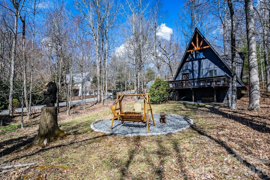 Discover the mountain gem you have been waiting for. Park the car and retire the keys because this prime location is just steps away from the 45 acre lake, heated pool, beach, game room and a variety of activities. This turnkey mountain retreat comes fully furnished featuring 3-bedrooms and 2 baths. The updated kitchen features stainless steel appliances and beautiful granite countertops, with a new gas range ready for the avid cook. Gather around the gas-log fireplace for a warm atmosphere while admiring the stunning murals. Step outside to a large deck for entertaining, overlooking an inviting fire pit area and nice yard for the dog and kids to play. This level spacious lot offers a variety of trees and plants, including rhododendrons, hemlock, and wildflowers. The home includes additional upgrades like a newer HVAC, metal roof, and driveway with convenient walk-in storage underneath the home. No updates or fixes required, just arrive and start living the mountain life. Linville Land Harbor is a sought-after community that includes water, cable, internet, 24/7 security, road maintenance, snow removal, weekly curbside trash removal, heated seasonal pool, nice sandy beach, stocked fishing waters, hiking, 18 hole golf course, clay like Har-Tru tennis courts, dedicated pickleball courts, covered shuffleboard courts, dog park, play ground holiday festivities, and seasonal concerts. Whether you choose to make this your full-time residence, a seasonal retreat, or keep it in the rental pool, all you need to bring is your suitcase to start enjoying mountain living at its finest! Must see to truly appreciate.