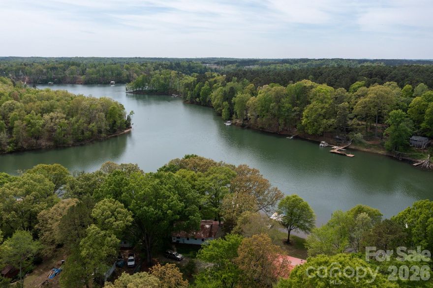 If you're looking for over an acre to build your next home on in Huntersville with views of Mountain Island Lake on a quiet dead-end street, this is the opportunity for you.  The property is located in a peaceful cove across from the Historic Latta Plantation property and about a mile from Neck Rd Public Boat Ramp.  No HOA.  Water and Sewer is available on this street and tap fees will be required to connect.  Currently there is a mobile home in place on this lot with a private well and 2 bedroom septic system.  There is a tenant in place in the mobile home, do not disturb them.  There is no value in the mobile home and no showings will be allowed of the mobile home.  Please schedule a showing to walk the property so that the tenants are aware of buyers being there.  There isn't an available survey of the property, but a plat map is available and in attachments. There is a 15' ROW that runs along the right side of the property for access to rear parcels and is shown on the plat map. The property is Sold As-Is, the value is in the land - not the mobile home.  The age and approximate square footage of the mobile home is an estimate and no professional measurements have been completed.