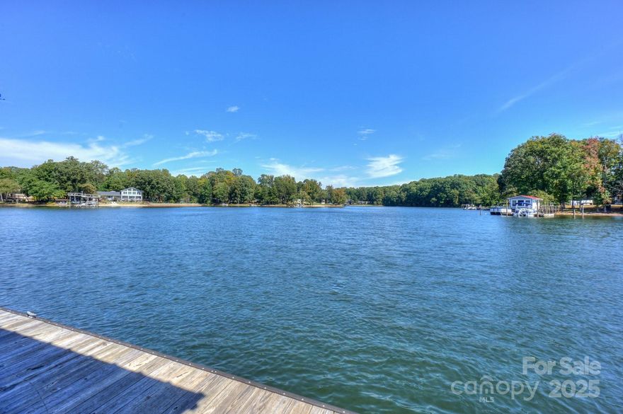 MEMORIES MADE AT LAKE NORMAN LAST A LIFETIME!!  MUST SEE.  This rare opportunity is an impressive property located at 8412 Ediths Ln, Terrell, NC 28682. This unique home offers an expansive living space of @5000+ square feet (actual professional measurements and floor plan coming next week) on a generous .81-acre lot and 164 ft of waterfront in a peaceful cove offered at $1,374,999. No HOA

The dwelling boasts three spacious bedrooms, the primary enjoys his and hers en-suite bathrooms connected by a Walkin closet, there are three additional full bathrooms for guests' convenience. The interior features are not only practical but spacious for entertaining or vacationing. Stainless steel appliances add a sleek touch to the large main level kitchen that any culinary enthusiast would appreciate the ample workspace and for friends to enjoy congregating on the main level. 

This residence basks in natural light thanks to the many windows on the lake side. These windows not only illuminate the home but also offer stunning year round views of the lake. There is ample storage space in the walkouts off second floor. Second floor has plenty of flex space for office or playrooms - all have closets. The large screened in porch creates an outdoor oasis for morning coffee and evening drinks.
One unique feature of this property is its lakefront location complete with an extra-large dock and deep water. Water enthusiasts will appreciate the two boat lifts and private boat launch providing direct access to aquatic adventures right from your backyard. Cruise to main channel and open water in minutes with no bridges.
The lower level houses a walkout basement - perfect for creating a game room, home office, gym, theatre or whatever suits your lifestyle needs. A second kitchen off basement makes effortless indoor and outdoor entertaining.
Additionally, this property includes a rented apartment which can serve as a guest suite or potential income generation opportunity.  It is currently rented until 5/31/2026 $1250 and under property management. The size of main home also creates opportunity for multi-generational living or a vacation rental.
Outside you'll find the opportunity to enjoy lake life continues with an extensive yard ideal for outdoor activities or simply enjoying the tranquil scenery that Terrell and the lake have to offer. Golf cart path to the water and room to park.  Outdoor buildings and 2 carports have ample storage for lake toys- kayaks, boats, golf cart etc. A golf cart/ sidewalk at water's edge easy access from home.

Terrell and Sherrills Ford provide numerous amenities for residents including local shops and restaurants as well as parks and recreational facilities. It's known for its friendly community atmosphere and easy access to larger urban areas when desired.

In conclusion, 8412 Ediths Ln offers not just a house but a lifestyle home filled with family fun and comfort combined with the charm of lakefront living in beautiful Terrell, NC. Whether you're seeking tranquility or adventure (or both), this property could be your perfect match.  Bring your friends and family and make memories!