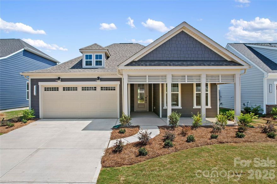 Welcome to Carolina Riverside, the premier 55+ active-adult community in the Charlotte area! Perfectly located within charming Belmont, you have easy access to the Catawba River and Charlotte-Douglas International Airport. This community combines small-town charm with easy access to city conveniences. Residents enjoy HOA-included lawn care, high-speed Internet and TV, a full-time Lifestyle Director, and resort-style amenities—featuring a 19,000 sq. ft. clubhouse, indoor and outdoor pools, pickleball courts, and scenic walking trails. This beautiful "Prestige" home offers 2 bedrooms and 2.5 baths in an open-concept design ideal for entertaining. The gourmet kitchen includes a wall microwave+oven with gas 36" cooktop, while the bright sunroom and paver patio provide sunny enjoyment. Additional highlights include a gorgeous brick fireplace, stunning interiors and an over-sized garage. Your time is NOW!
