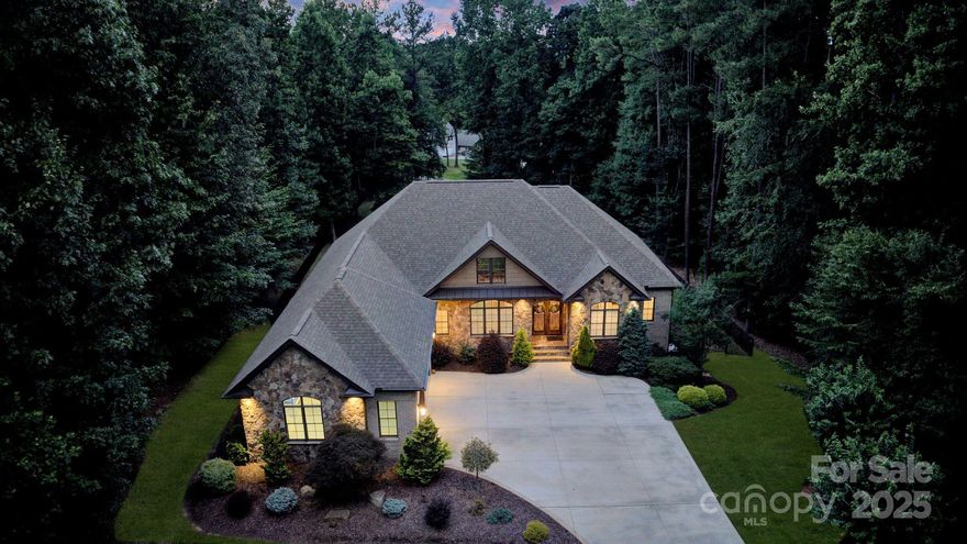 This spacious, custom-built ranch with a walk-out basement is sure to impress any homeowner. As you enter the home, you’ll be greeted by a gorgeous coffered ceiling in the dining room, a stunning stone fireplace, and a chef’s kitchen that will delight any cook. Enjoy your morning coffee on the screened porch just off the kitchen, overlooking the tranquil backyard complete with a pool, waterfall, spa, and outdoor fireplace. Host family and friends in the fully finished basement, featuring a second kitchen, an additional bedroom, a full bath, and a garage/workshop. If you’ve been dreaming of the perfect space to build a detached garage, look no further — the back of the property is easily accessible from Marietta Road, making it the ideal spot to add the garage of your dreams. Additional upgrades include, new main level HVAC in 2024, tankless water heater, full inground irrigation,  generac generator, and gutter guards. Newly installed hydro-hoist lift in boat slip to covey.