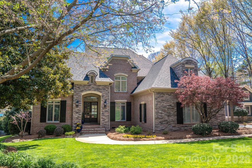 Experience the pinnacle of lakeside luxury in this meticulously remodeled Sailview estate, where sophisticated design meets the tranquility of the Lake Norman shoreline. Positioned on a sprawling 3/4-acre lot, this property boasts one of the community's most expansive shorelines, complete with a rare private beach and breathtaking, unobstructed main channel views. Every inch of this home has been thoughtfully reimagined through extensive recent renovations, starting with a dream kitchen. This space features high-performance Wolf and Sub-Zero appliances, custom cabinetry, and exquisite exposed beams that add warmth and architectural character, all flowing seamlessly into living areas wired with a whole-home Sonos surround system for an effortless entertaining experience. Modern security and connectivity are paramount, as the entire home is equipped with a Ubiquiti network featuring an integrated AI camera system for total peace of mind. The primary suite serves as a private sanctuary, offering a custom-organized owner's closet and a spa-like bathroom with radiant heated floors for ultimate comfort. Step outside to your private backyard oasis, where a large covered porch anchored by a cozy gas fireplace offers the perfect vantage point to watch the sunrise over the water. Your lakeside lifestyle is further elevated by a newly built, fixed covered dock designed for boat and PWC storage. Within the community, enjoy access to Sailview’s world-class resort amenities, including a community pool, clubhouse, pickleball, tennis, and sand volleyball courts, making this a truly uncompromising property in one of Denver’s most coveted lakefront communities.