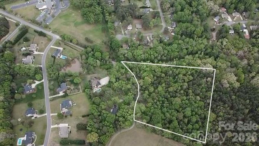 5 acres of private, beautiful, wooded land available NOW!  Over 538 feet of road frontage. Not in the city limits of Rock Hill but adjacent to shopping, restaurants and all of the amenities of city living. This parcel has NO HOA or CCRs so it can be developed with everything allowed in York County RMX-20 zoning. The possibilities are endless! Per York County utilities, no public water or sewer available. Buyer to install well & septic. No perc test on file. Property taxes are currently under Farm Use Value. Buyer to pay any rollback taxes. School information subject to change. Pink flagging tape will show approximate parcel boundaries at road frontage beginning and end; not official survey markings.