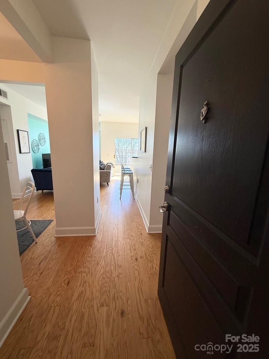 Located in the heart of Dilworth this 1 bedroom, 1 bath w/ dining room condo is move in ready. So many NEW/updated features included in this home such as the HVAC, Kitchen Aid refrigerator, microwave, dishwasher and double oven, AND LG full size stackable washer/dryer! Hardwood floors, updated primary bathroom w/ custom tile, glass shower door, vanity, mirror & floor. The primary bedroom has a huge walk in closet, large windows that show off how much natural light are in this open floor plan home. Enjoy sipping a cup of coffee on your balcony or grill out with friends on the roof top terrace. Access this secure building with your code/fob along with ample space to workout in the fitness and yoga room. For your convenience there is an amazon locker to safely store all your deliveries. UPS/Fed Ex also has a delivery station inside the lobby.  So many places minutes away to dine, shop, and enjoy all the outdoor activities Freedom Park has to offer! Fresh Market is right across the street.