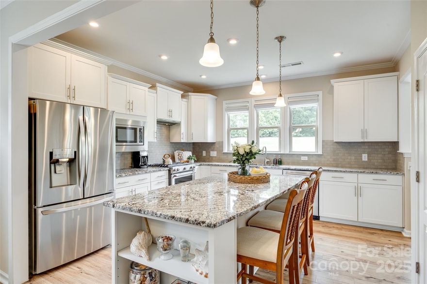 Unmatched quality, this better-than-new Carolina Orchards 55+ community home is seeping w/ charm! A relaxing front porch greets you as you make your way in on stunning LVP floors that run throughout the downstairs common areas. The kitchen is sure to impress w/ gas range & expansive island, & sunroom looks onto the flat & fenced yard, w/ close to 300 sqft of paver patio! In the primary suite you'll enjoy a tray ceiling, walk-in tiled & frameless shower, dual sinks, & more! Rounding out the downstairs is a guest bedroom & bathroom, & office. The upstairs adds space & flexibility, w/ a loft, bedroom, & ensuite bathroom. Storage abounds w/ large closets throughout, & even a walk-up attic from the oversized garage (w/ sink & tankless hot water heater). Carolina Orchards is a conveniently located, lifestyle rich community, w/ indoor & outdoor pools, fitness center, sport courts, dog park, full time activities director, & near the Anne Springs Greenway - enjoy the best years ahead in style!