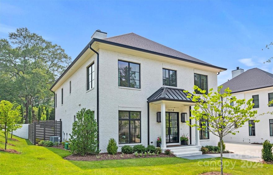 Exquisite duet situated in desirable Eastover! Built in 2020 with numerous upgrades, 2058 Vernon lives like new construction. Oversized windows on all sides bathe the home in natural light. Gorgeous moldings & an abundance of shiplap paneling are accentuated by high-end designer selected fixtures & finishes throughout. Custom Sightline steel doors in the front entry, LR/office & scullery. 9” white oak wide plank flooring, extra thick 8’ doors, & 10’ ceilings on BOTH floors! Chef’s kitchen boasts custom cabinetry, quartz countertops, marble backsplash, high-end appliances incl. Wolf gas range & SubZero fridge plus scullery w/ prep sink. Beautiful front formal rooms plus family room & upstairs loft. Luxurious primary suite w/ extensive built-ins & spa like en-suite. 2nd primary on upper level! Covered terrace w/ ceiling mounted heaters & private patio are perfect for entertaining! Attached two-car garage plus ample driveway parking. Absolute oasis just minutes from Uptown or SouthPark.