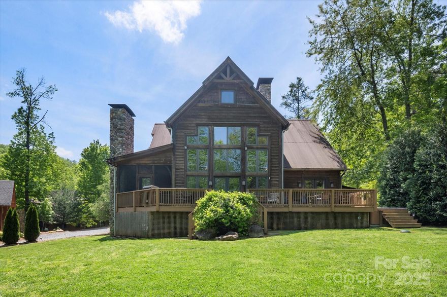 Discover the ultimate Lake James lifestyle in the gated community of The Arbor. This stunning craftsman home showcases remarkable post-and-beam construction, with exposed beams & cathedral ceilings. Large windows frame breathtaking views of the lake, inviting the natural beauty indoors. The interior highlights natural wood finishes, custom-built-ins, & a grand wall of windows. The main floor features a well-appointed primary bedroom suite & a guest room. Upstairs, you'll find a loft, a wet bar, a bunk room, a bonus room, & two extra bathrooms. Gather in the living room or the inviting screened-in porch, both featuring beautiful fireplaces. This meticulously designed turn-key residence is ideal for entertaining & accommodating guests. Enjoy a usable backyard that includes a spacious private double-decker dock, perfect for your boating & water activities. Whether for personal enjoyment or as a short-term rental, this home makes the perfect retreat in the heart of Lake James.