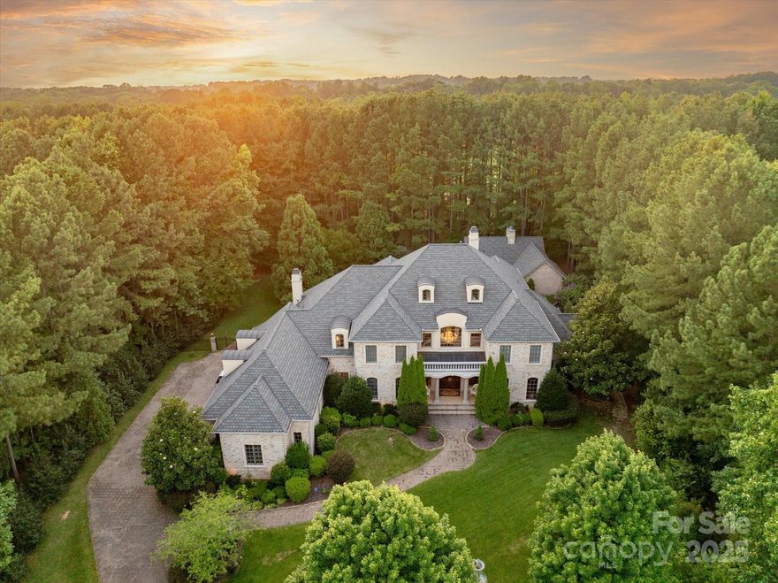Luxury estate home w/ 4-car garage in gated Woodhall on 1.68-acre premium lot w/resort-style backyard—pool, covered cabana w/ fireplace, & 554 SF pool house w/ full bath & kitchenette. Rich finishes thru-out: mahogany-paneled study, solid core doors, custom moldings, ceiling details & built-ins. Grand 2-story foyer opens to Great Room w/sweeping views of private yard. Chef’s kitchen features commercial gas range, hood, Subzero fridge & custom ceiling-height cabinetry, open to keeping room w/fireplace. Main-level primary suite has sitting room/office, coffee bar, 2 custom walk-in closets, & spa-like bath w/separate tub & shower. Upstairs offers 4 oversized BRs w/ en-suite baths, large bonus room w/wet bar, & separate theater room. Exterior includes paver patio, lush landscaping, expansive paver driveway, well for irrigation, encapsulated crawlspace, 50-yr roof (2018), updated HVAC, & aluminum-clad windows. Home backs to private horse facility & is across from Marvin Ridge Middle & High.