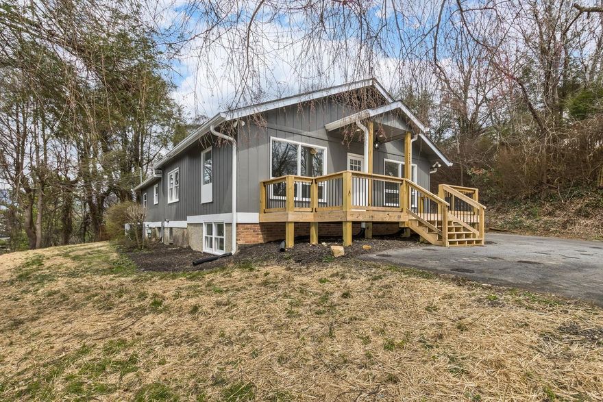 Beautifully updated one-level living in a convenient Black Mountain location! South-facing Great Room has vaulted ceilings with lots of light. Enjoy winter mountain views and beautiful sunsets. Sip your coffee on the spacious new front deck. The kitchen has new white shaker cabinets with soft-close doors & drawers, all new stainless steel appliances, granite countertops, & a large undermount sink. Large master suite has dual vanities and new shower/tub. New vinyl plank flooring throughout. In addition to the master suite and 2nd bedroom, there is a center room with a closet near the main bath. The 220-sq ft bonus room downstairs would make a great office or play room and is not included in total square footage of 1,848 sq ft (ceiling is just under 7 ft high.) Additional attached storage room is accessible from outside.  Just a 7-minute walk to Ingles (Phil's Bar-B-Que Pit is even closer) and a 5-minute walk to Cheshire Mountain Village which includes The Black Bear Tavern & much more!