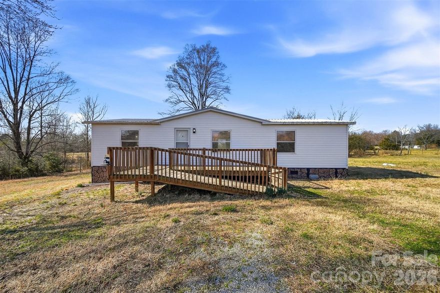 3 bed, 2 bath manufactured home sitting on 1 acre in Maiden, NC. This home features an open floor plan with updated flooring, fresh paint, and a clean, modern kitchen with plenty of cabinet space and a large island.

The primary bedroom includes a private bath, and the two additional bedrooms offer flexibility for family, guests, or a home office.

Out back, you’ll find a spacious deck overlooking the yard — perfect for grilling or relaxing. There’s also an above-ground pool and plenty of room to spread out, garden, or add a workshop.

Quiet setting with room to breathe, just a short drive to town.