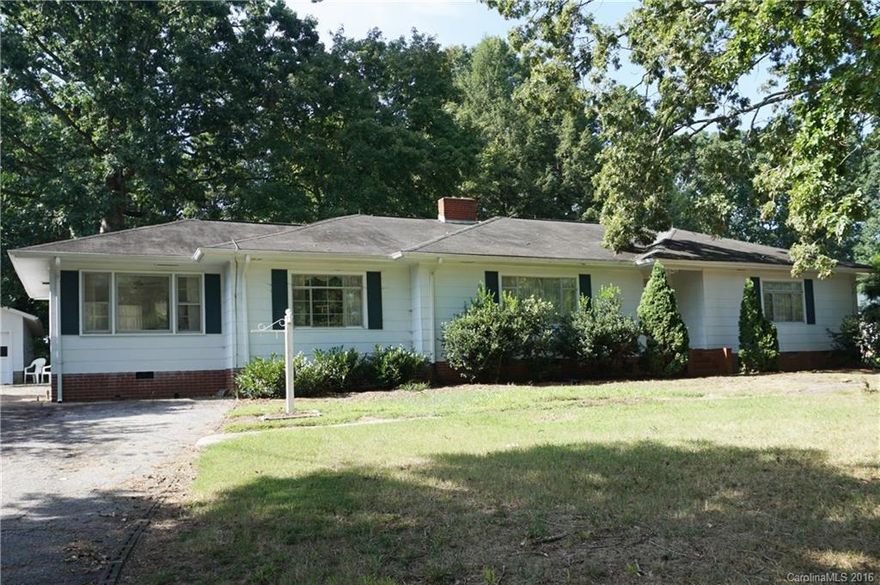 Located in Western Rowan County, this home features 3 bedrooms, 1 bath, living room, den, dining room, eat in kitchen, and covered back porch/patio.  The kitchen has an electric wall oven, countertop range, and dishwasher.  Fireplaces in both living room and den.  Detached double garage.  Lots of open area that could easily be pasture or additional building areas.