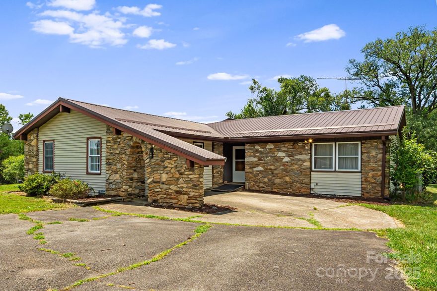 Imagine finding a charming home in the peaceful countryside of Marshall, awaiting your personal touches - welcome to 289 Morlin Acres. With stone accents and a spacious layout, this home is perfect for families looking to put down roots. Inside you’ll find beautiful hardwood floors, a bright kitchen with plenty of storage, and inviting living spaces ready for gatherings. Enjoy mornings on the screened-in porch or cozy evenings in the large family room. Split floor plan and flexible spaces make it easy to create a home office, playroom, or guest space. The basement provides additional storage or finished basement potential with kitchenette and private entrance. Outside, the large yard offers room for kids and pets to play plus a fenced area, 4-bay parking garage, powered storage shed, and a barn for projects or animals. Just a 15 drive to Weaverville, you’ll enjoy the perfect balance of country living with nearby convenience. Make this special house and property your family’s next home.