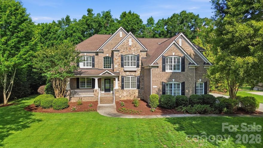 Located in desirable Marvin Creek this stunning full brick home with pond views, fully finished walk out basement, and freshly painted interior is ready for you to call home. Located on a premium .75-acre lot, a rocking chair front porch greets you. Step inside to find over 7400 square feet of living space! On the main level you will find a grand entry hall, a formal dining room with tray ceiling and a living room that leads to the two-story great room with floor-to-ceiling windows and gas fireplace. The great room opens to a spacious gourmet kitchen featuring a large island with a breakfast bar, granite counters, walk-in pantry, and a 5-burner gas cooktop. The kitchen opens to a bright and airy breakfast room, perfect for casual dining. The main floor also features the primary suite - a special retreat for the home owner featuring a tray ceiling, a sitting room, a double sided fireplace and a luxury bath with soaking tub, walk-in shower and generous size custom walk-in closet. A conveniently located laundry room and half bath completes the main level. On the upper level you will find a reading nook with built-in book shelves, a loft area with built-in desk, 3 generous size bedrooms, 2 full baths and a huge bonus/5th bedroom. On the lower level, the fully finished walk-out basement will make you never want to leave! This ultimate entertainment and relaxation zone includes a large rec room with fireplace, a flex room, full bath, fully equipped theater room, office, a game room, gym area, kitchenette with barstool seating and a storage/utility room. Other highlights include two separate staircases ensuring easy flow throughout the main and upper level, plantation shutters, custom built-ins and plenty of walk-in storage areas throughout. Enjoy outdoor living on the back patio with views of the manicured back yard, an outdoor kitchen, fire-pit and fireplace. Other exterior features include a 3-car side-load garage, large driveway with plenty of parking space and water views of the pond with fountain. Marvin Creek offers exceptional neighborhood amenities that include multiple pools with a lazy river and waterslides, clubhouse, basketball and tennis courts and walking trails.