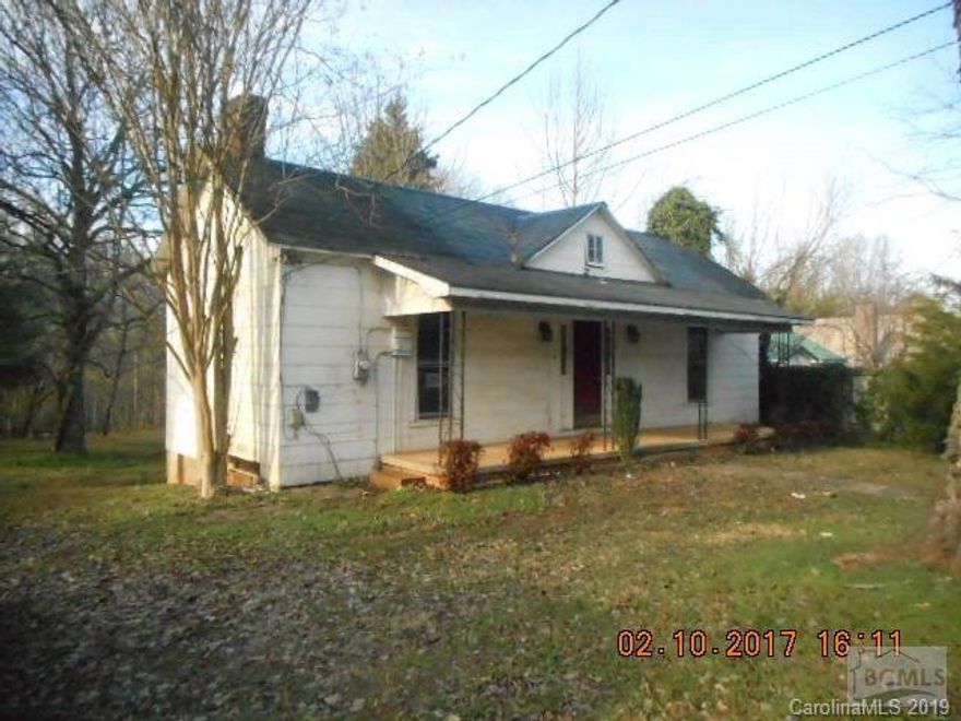 Most of the house has high ceilings except enclosed porch area, which is 217 HSF, includes bathroom and laundry, and is below 7 feet.  Great location, close to I-40, downtown, hospital, and restaurants.  This 2 bedroom, 1 bath home on extra large lot has large rooms and each bedroom has 2 closets.  Most windows have been replaced.    Sold AS-IS.  Heat source is unknown.  Functionality of systems is unknown.  Financing available through First National Bank of America.