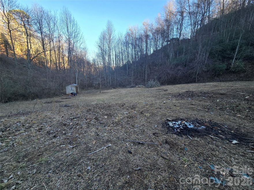 Bryson City - Recently cleared, unrestricted property that lays well. Convenient to downtown, grocery shopping, Deep Creek, tubing, hiking, and Harrah's Cherokee Casino. Bring your RV, tiny home, mobile home, barndominium, animals, or chickens. Featuring a stream, 3 bedroom installed septic, and a spring that could potentially be brought back to use. Don't miss this rare find!