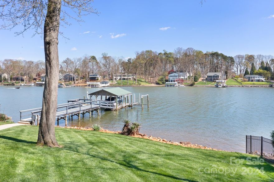 MILES OF WATER VIEWS, A GENTLY SLOPING LOT, A COVERED DOCK WITH 2 BOAT LIFTS, AND A SITTING AREA ON THE PIER are only the beginning of this magnificent waterfront retreat. Situated on a LARGE COVE, & a half-acre lush lot, this 3 bedroom 3 full & 2 half bath home defines LAKE LIVING. The recently renovated kitchen is bright & airy with plenty of workspace. The main level primary bedroom is complete with a WIC & covered patio access; the ensuite has heated tile floors & a steam shower. This home has 3 FIREPLACES. One propane-gas burning logs in the living room, & wood burning in both the study & dining room. Both these rooms have access doors to a private courtyard. Both upper bedrooms are quite spacious, each with an attached ensuite. The back BR has magnificent Lake Views. The Basement makes for great workshop space (there is a utility sink) and storage. There is a roll-up access door to storage under the deck. Wonderful opportunity for LAKE LIVING or potential rental investment.