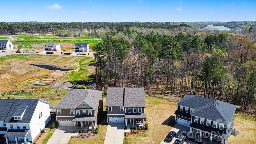 Welcome to this FULLY FINISHED BASEMENT HOME on a CUL DE SAC lot!! A beautiful new construction community by DRB Homes (built in 2025), offering the perfect blend of luxury living and waterfront accessibility. This stunning, newly built home is one of the few highly sought-after walkout basement floorplans in the neighborhood built and move in ready! This spacious property features 5 bedrooms and 4.5 bathrooms, designed with an open floor plan perfect for modern entertaining. The main level is appointed with Luxury Vinyl Plank (LVP) flooring throughout and includes a dedicated office space with French doors, a formal dining room, and an expansive open living room flowing into the gourmet kitchen. The chef's kitchen boasts a large quartz countertop island, top-of-the-line stainless steel appliances, and abundant natural lighting. Upstairs, retreat to the spacious primary bedroom suite, complete with a dual vanity bathroom and a massive walk-in closet. The finished walkout basement is a true highlight, featuring over 1100 square feet of versatile entertaining and living area, including a full fifth bedroom and full bathroom. Outdoor enjoyment is guaranteed with a large 12x10 wood deck overlooking your private backyard and wooded area, complemented by a full extended patio accessible from the walkout basement. Enjoy an unparalleled location just a short walk from the shores of Lake Wylie and the recreational amenities of the Allison Creek Waterfront Park. Lender to cover first 3 MONTHS of buyers INTEREST on the loan. Ask your agent about this incentive!!