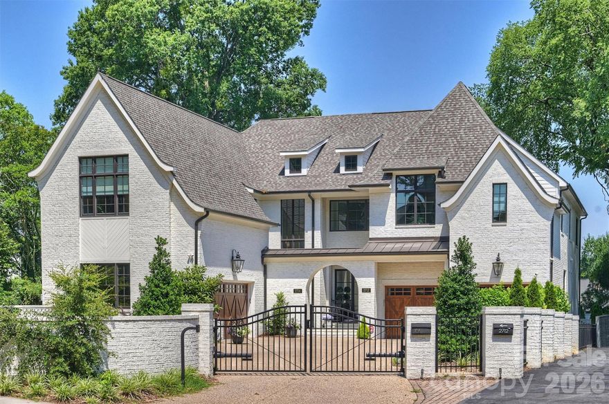 Stunning home with gated entry and private rear yard in the desirable Selwyn area of Myers Park. A beautiful bluestone courtyard with ample guest parking welcomes you to the striking white brick exterior and dramatic black steel-and-glass front door. Inside, a sweeping curved staircase sets the tone for the thoughtfully designed interior. The main level features a formal dining room with beamed ceiling, a butler’s pantry, and two spacious walk-in pantry areas for exceptional storage. The gathering room showcases a wood-beamed ceiling and a dual-use gas or wood-burning fireplace, creating a warm and inviting focal point. A sliding wall of glass opens to the covered terrace and private rear yard, offering seamless indoor-outdoor living. The handsome study off the living area also opens to the terrace, providing a peaceful space for work or relaxation. The well-appointed kitchen features quartz countertops, custom cabinetry, and premium JennAir appliances including a 36-inch dual-fuel range, wine cooler, and microwave drawer. Upstairs, the home offers a spacious bonus room, three ensuite bedrooms, and a convenient laundry room. The owner’s suite features a vaulted beamed ceiling, spa-inspired bath, and an exceptional walk-in closet. The home is also pre-constructed to accommodate a future elevator. Front and rear gardens are surrounded by stately brick walls and iron gates, enhancing both privacy and charm. Ideally located near shopping, dining, grocers, theatre, and just minutes from Uptown Charlotte.