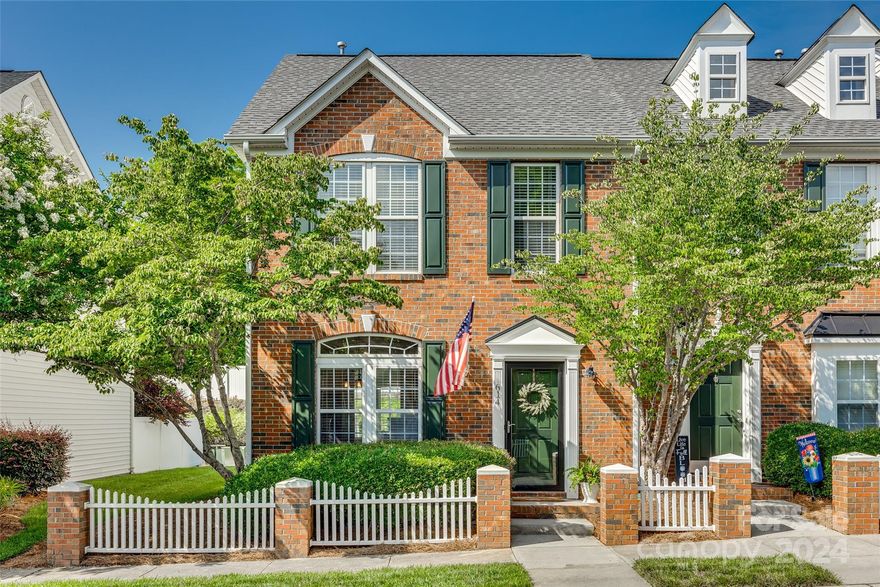 Adorable end unit townhome nestled amongst mature landscaping, street lights, sidewalks and picket fencing.  Kitchen features granite countertops, tile backsplash, dining area and extra bar seating. Great room with ceiling fan and lots of natural light. The second level boasts two spacious bedrooms with private baths. Primary ensuite with large walk in closet and bath featuring shiplap accent wall and updated vanity. New paint throughout the home. Back patio has plenty of room for entertaining and enjoying the outdoors.  Manchester Village features a community pool and clubhouse. Minutes away from I-77, shopping and restaurants.