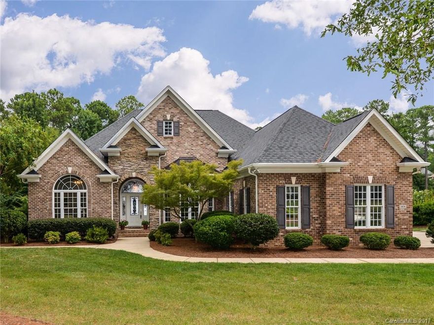 Prepare to be impressed with this full brick executive home nestled on .73 acres in desirable Water Edge. This custom built ranch home with a full basement is loaded with options! 11 foot ceilings on main level. Huge great room with vaulted ceiling. Stone fireplace. Tons of hardwoods. Heavy molding. Private master suite. Built in home vacuum. Screened porch. 4 car garage with HUGE space for workshop. Basement has bedroom & baths with possibility of incredible IN-LAW SUITE. Irrigation. Generator.