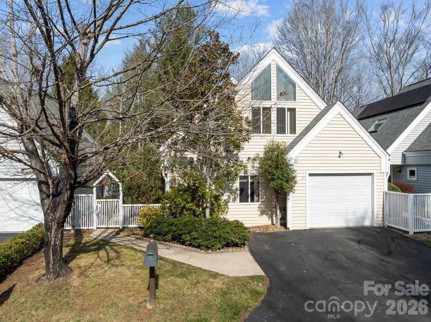 Just minutes from the historic Country Club of Asheville, which offers golf, tennis, and aquatics amenities, this charming NORTH ASHEVILLE home provides a wealth of conveniences. Enjoy the fantastic walking paths at Beaver Lake, The Fresh Market, and Jones Park, all just a few minutes away. Green thumbs will love the dedicated gardening space situated right outside the dining room and kitchen windows. The main level features the living area and primary suite with a full bath, and a half bath. Also on the main level, a heated and cooled sunroom opens to the lovely common area behind the house, with its serene atmosphere, and the soothing sounds of Beaverdam Creek, which did not reach the house during Hurricane Helene—no storm damage here! The kitchen features newer cork-backed flooring, complemented by a brand new range, newer dishwasher and refrigerator. The flooring in the entryway, living room, and dining area is all less than five years old, and many windows were replaced just two years ago- Renewal by Andersen! The upper level offers a large loft area, the third bedroom which has been used as an office, and the large second bedroom with a vaulted ceiling, which would also make a very nice work from home space.  New interior paint in most rooms just completed after professional wallpaper removal. Water and sewer charges are included in the reasonable HOA fee! Come see this one today!