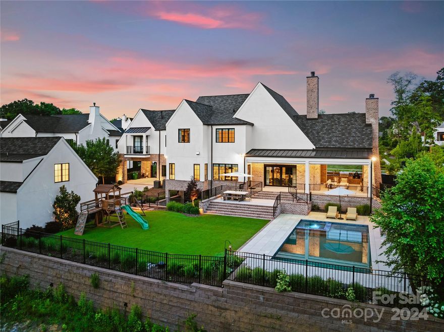 Experience the epitome of luxury living in this stunning custom built home located in the coveted Cramer's Pond neighborhood, in the heart of Plaza Midwood - steps away from the prestigious Charlotte Country Club. The expansive open living area boasts vaulted ceilings with gorgeous wood beams, floor to ceiling fireplace and sliding doors that are an entertainer's dream. The gourmet kitchen is a culinary marvel with bespoke cabinets, top-of-the-line appliances and a hidden scullery. Retreat to the Primary Suite with a spa-like en-suite bathroom complete with a steam shower, soaking tub and a boutique-style walk-in closet. Step downstairs to the fully finished basement for a round of pool, a beer on tap or a home theatre movie. The perfect outdoor oasis features a pool, hot tub, turf, outdoor kitchen & wood burning fireplace. Additional amenities include a full home audio system (indoor/outdoor), gated entry to the Porte-cochere, and an ADU. Every detail has been meticulously curated!