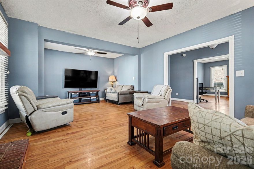 Step into timeless charm with this beautifully preserved 1901 home, thoughtfully updated and set on a spacious 1.43-acre level lot with mature trees. Offering over 2,600 square feet, this two-story home blends historic character with everyday functionality.

A wide, inviting front porch welcomes you in—perfect for relaxing mornings or evening gatherings. Inside, you’ll find tall ceilings, abundant natural light, and warm wood flooring throughout. The spacious family room features a classic fireplace and detailed trim, creating a cozy yet elegant focal point.

The kitchen is both stylish and practical, with white cabinetry, a large island, and plenty of prep space—ideal for cooking and entertaining. The main-level primary suite provides comfort and convenience, while upstairs offers two additional bedrooms and a full bath—perfect for guests, a home office, or flex space.

Outside, the expansive lot offers endless potential for gardening, recreation, or simply enjoying the open space. A detached garage with nearly 1,000 square feet plus an additional outbuilding provides exceptional versatility for storage, hobbies, or a workshop.

With no HOA and a rare combination of space, character, and flexibility, this property is a unique opportunity to own a piece of history tailored to modern living