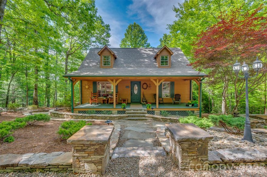 Escape to your own private mountain retreat! This amazing 3 BR, 3 BA cabin is tucked away in the woods on 3.08 private acres, offering the perfect blend of rustic charm and peaceful living. From the moment you arrive, you'll fall in love with the incredible stonework, inviting covered front porch and serene natural setting. Inside, the stunning great room features soaring ceilings, warm wood finishes and an open loft overlooking the living area, creating the perfect cozy cabin atmosphere. Enjoy relaxing evenings by the fireplace or entertaining family and friends in the spacious open-concept living space. Step outside and experience true outdoor living with a beautiful screened back porch, outdoor fireplace and tranquil waterfall feature-all surrounded by nature. Whether you're looking for a full time residence, mountain getaway or vacation rental opportunity, this one of a kind property offers privacy, comfort and unforgettable charm. Winter views of South Mountains. A rare opportunity to own your own peaceful cabin retreat in the woods! An additional adjoining two tracts consisting of 5.69 acres and 3.09 acres could possibly be purchased. Roof new in Sept. 2025. Security system and cameras with Shelby Alarm.