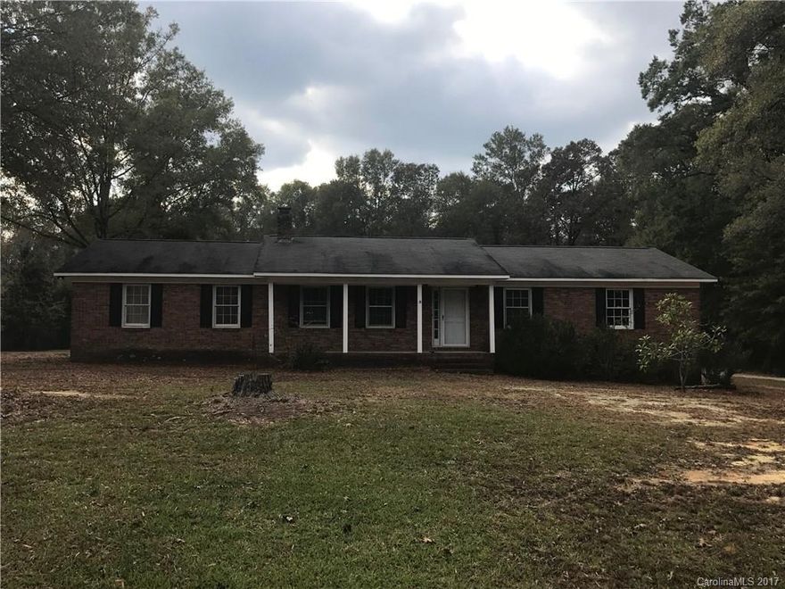 Brick home on 4 acres with 3 BR and 2 BA and double garage.  Be the one to update this home and personalize the decor.  This home ha great bones and awaits its new owners to give it a facelift.  Possibilities are endless!