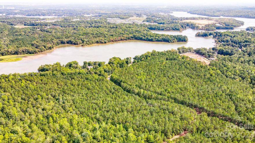 Bring your horses on this just over 11 acre estate lot!  Located near the new Drift restaurant on Lake Wylie, public boat ramps, McLean, and the new Morning Star Marina where you can keep your boat in dry storage! Surrounded by 10+ Acre homesites, looking for peace, serenity & relaxation? This gorgeous wooded, level lot is the perfect place to build the forever home of your dreams.  Surrounded by 10+ Acre homesites.  This homesite offer unlimited possibilities for outdoor living! Picture yourself having your morning coffee overlooking the peaceful views and enjoying the abundant wildlife.  If entertaining is your passion, the possibilities are limitless. Enjoy the best of both worlds- peaceful, quiet country setting, yet convenient to beautiful Belmont with a small-town feel, but oh-so convenient to uptown Charlotte, shopping, dining, and the airport.
