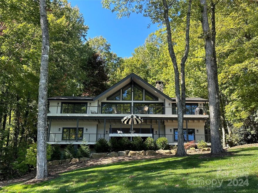 Absolutely stunning, move-in ready 4 BR, 3 BA, and two half bath home that was taken down to the studs and completely renovated in 2021 with new roof, windows, floors, doors, appliances, cart path to the lake, and two car carport. This stunning turnkey home is on a large, gentle lakefront lot overlooking the Lake Toxaway Marina, Greystone Inn with beautiful backyard, stone patio adjoining the lake, new stationary dock with ladder, and gentle cart path between the house and lake. This exceptional property also features a generator, encapsulated crawl space, irrigation system, mud room with separate entrance, high-end interior and exterior lighting, and the best location for convenience to all amenities at Lake Toxaway.