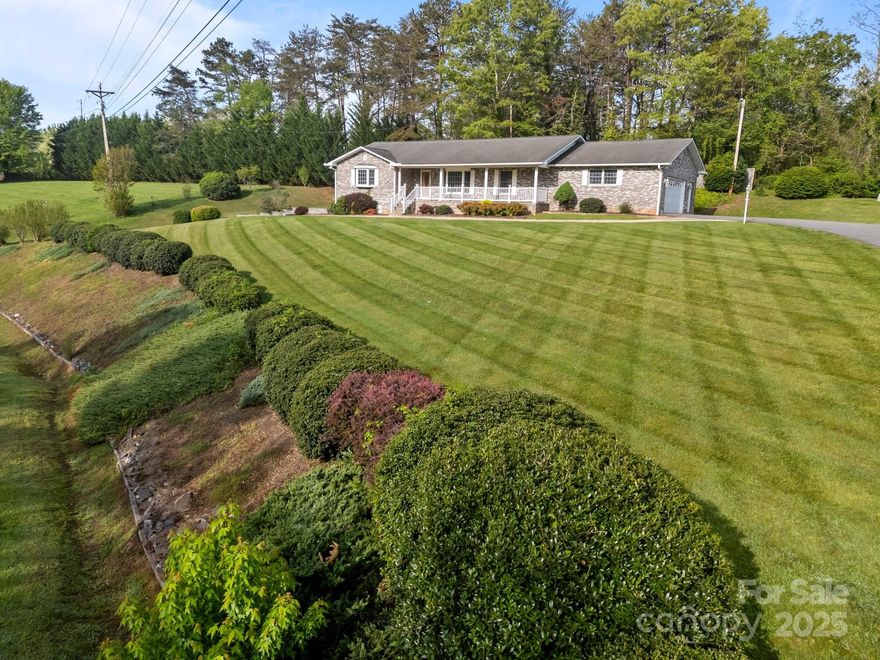 RECENT APPRAISAL!!   LOCATION LOCATION LOCATION!Looking for an extremely CONVENIENT location and IMPECCABLY cared for home? This IMMACULATELY MAINTAINED 3 bedroom 3 bath ranch style home situated on  1+ acre of lush green rolling lawn is it!! 5 min to Weaverville ,10 min to Mars Hill and Marshall & 20 min to Asheville! This beautiful brick home is bathed in natural light with COVERED front porch, VAULTED ceilings and enormous kitchen with tons cabinets & storage! Large breakfast bar & dining room that flows effortlessly on to the private back deck or into the huge living area! Great for entertaining family and friends! Ensuite primary! Gigantic basement offers tons of potential!The home includes a thoughtfully placed mud room/ laundry room, adding to the functional layout! Easily park your vehicles, lawn equipment or ATV in one of the THREE oversized garages or TWO driveways! Even includes a storage shed! Make this gorgeous home yours!!!