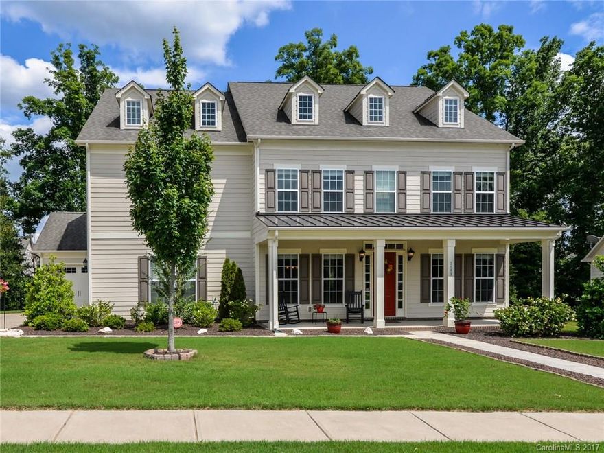 Stunning 5500+ sq ft home w/ 6 beds & 5.5 baths has EVERYTHING! Deck overlooks private fenced yard. Spacious home w/ open floorplan, office, & 3rd flr media rm (82" TV incl). Gourmet kitchen w/ granite, huge island, SS appliances. Upgrades include HW flrs, 10' ceiling, built-in shelves, surround sound. Lots of storage w/ walk-in closets & 3 car garage. Large beds with ensuite baths. Walk to playground, tennis, pool w/ slide. Fort Mill top-ranked schools & low SC taxes.