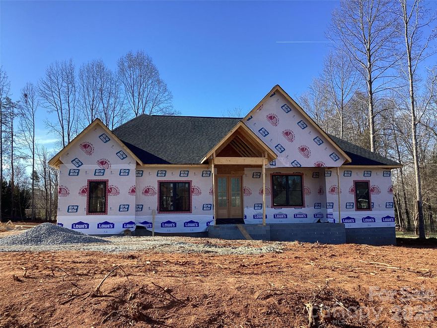 This beautiful new brick veneer home with stone accents, is being built in the exclusive East Rowan, Grand Oaks development. In fact, this .66 lot is the last one available! The  spacious 2600 sq.ft. home has 3 large bedrooms, 3 1/2 baths and an entertainment room on the second level. The master suite has a custom tiled shower, large tub, with granite top on the dual sink vanity. The awesome walk-in master closet will hold the wardrobe of a queen! The kitchen includes custom cabinets, stainless natural gas appliances, granite countertops on the cabinets as well as on the island. The dining room adjoins the kitchen. When entering through the front door, the large great room opens up to all kinds of entertainment possibilities! With the split floor plan, the other two bedrooms  share a roomy bathroom with combination tub/shower. Again, countertops will be granite. Separate laundry room is very spacious and wired and plumbed for washer/dryer. Large covered rear porch has lots of possibilities, such as an outdoor kitchen . Front entrance is a covered porch as well. Two car garage is side entry. In the early stages of construction, a buyer could make choices on features of the home.