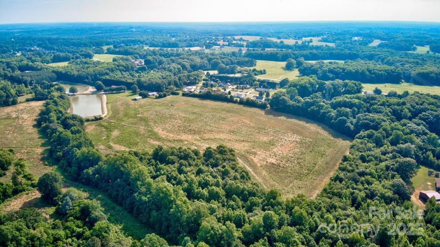 30 Acres in Cool Spring!!! What more could you ask for? This parcel sits off a private road just minutes from HWY 64, I-40 and I-77.  Land has approximately 23 acres cleared and roughly 8 that is wooded.  Creek on west side of property.  You'll also enjoy the view of the lakes on the adjoining property. Acreage will include easement for access along Pop's Lake Rd., private road servicing lakes and residents that adjoin. Come build your private estate in this quaint corner of eastern Iredell County.