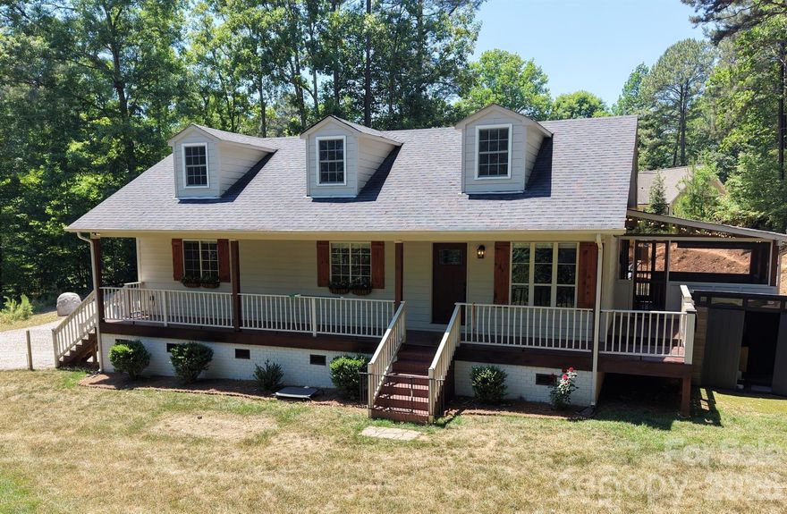 Beautifully updated home in the heart of Sherrills Ford, ideally situated on a quiet dead-end road with minimal traffic and peaceful views of Lake Norman. Positioned on a level half-acre lot, this property offers an exceptional blend of privacy, functionality, and modern smart-home living. Both the front and backyard are fully fenced, while the additional e-collar system offers added peace of mind for pet owners. Enjoy mornings on the expansive covered front porch overlooking the lake or relax year-round on the screened porch surrounded by the serene setting. The level yard provides outstanding usable outdoor space and an ideal setting for entertaining, pets, or everyday living.

Inside, this thoughtfully upgraded 3-bedroom, 2-bath home offers approximately 1,731 square feet of living area, including a recently remodeled upper-level space featuring 573 square feet of heated and cooled flex space. While the upper level is fully finished and climate controlled, portions of the area feature lower ceiling heights and angled ceilings, preventing it from being included in the home’s official heated living area calculation. The lower level encompasses approximately 1,158 square feet of primary living space, creating a versatile layout with exceptional functionality and flexibility.

The entire home is equipped with a full Lutron Caseta automated lighting system, along with automatic shades, cameras, thermostats, and a complete alarm system—all seamlessly controlled through digital video keypads or directly from your phone. The spacious open kitchen features quartzite countertops, pull-out cabinet shelving, an under-counter beverage refrigerator, and premium appliances including a brand-new refrigerator, plus washer and dryer that all remain with the home. Both bathrooms have been extensively remodeled with custom tiled walk-in showers and frameless glass doors, while the primary suite includes a custom-built closet organization system.

Major system upgrades completed in 2021 include a new HVAC system with all-new ductwork, a new water heater, and a whole-house water filtration and softening system. Additional highlights include LVP flooring, picture-frame trim accents, and an incredible 9.1 Dolby Atmos surround sound entertainment system with an 85-inch television valued at over $10,000, which conveys with an acceptable full-price offer. No HOA.