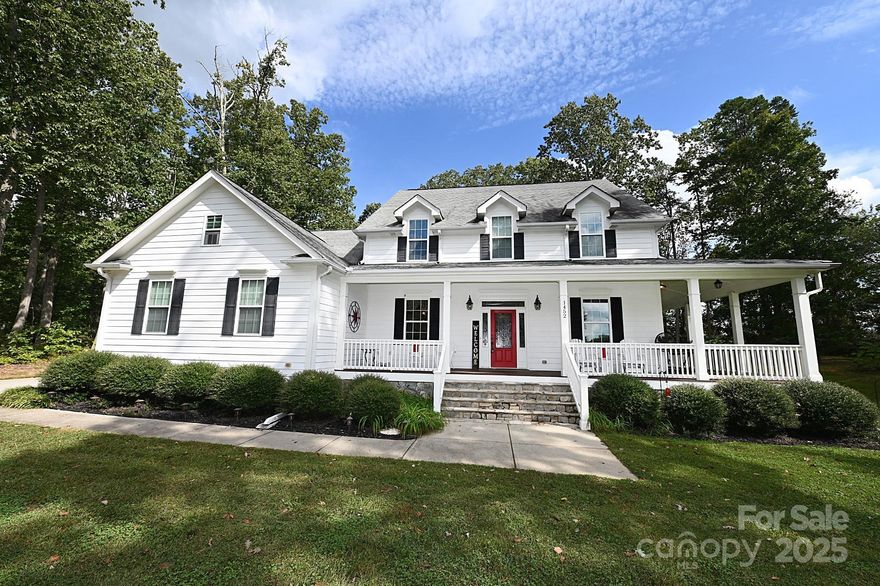 Charming and timeless, this classic farmhouse-style home sits on 1.6 acres in the desirable Goodsons Place subdivision. An expansive wraparound porch welcomes you and offers the perfect retreat for relaxing in privacy and country-like setting. Inside, the home features elegant details, including primarily hardwood flooring throughout, elegant crown molding, and a spacious kitchen designed for both function and style. The kitchen boasts granite countertops, a large center island with bar seating, a walk-in pantry and spacious breakfast nook. The main-level primary suite provides comfort and convienence with custom cabinetry, dual vanities, and a large tiled shower. Upstairs, you'll discover additional bedrooms-including one en suite- along with a generous bonus room and two full baths. With no city taxes and placement in the highly sought-after North Lincoln School District, this home is a rare opportunity to own both space and style in a truly ideal location.