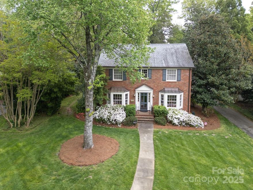 Classic Myers Park brick home with slate roof, high ceilings and beautiful hardwood floors throughout! Fantastic flow for entertaining and everyday living! Updated chef's kitchen with double ovens, gas cooktop, butler’s pantry, and abundant cabinetry.  Two large open gathering spaces, off the kitchen, both with fireplaces, offer easy access to the outdoor living areas. Charming arched doorways and bay windows with seats grace the study and dining room. Dining room also has fireplace and side screened porch. Generous primary suite with luxury bathroom and two huge walk-in closets.  Upstairs laundry with wrapping station/craft room. Stunning, private backyard with patio, hardscape and mature landscaping. Prime location — convenient to SouthPark and Uptown, and zoned for CMS schools: Selwyn, AG, and Myers Park.