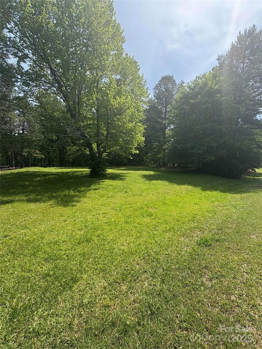 Don’t miss out on one of the most picturesque properties available in the sought-after Clover School District! This gorgeous, wooded parcel offers a gentle slope, providing the perfect setting for your dream home. Nestled across from a charming family farm and backing up to serene woods, this lot combines beauty with privacy. With light deed restrictions, and no HOA, you’ll have the freedom to create the perfect home. Embrace the beauty of country living while staying conveniently close to Lake Wylie and Charlotte.