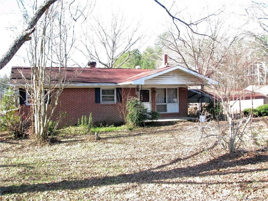 3 Bedroom 1 Bath Brich Ranch Home on 4/10ths acre lot.  Level Lot has pecan trees and shared drive (Perry St).  Carport and Small Covered Porch.  Hardwood floors and Woodburning fireplace with wood access door.  Power not connected, no one has lived in home for about 5 yrs.  Inheritied dwelling/lot being sold "as is".